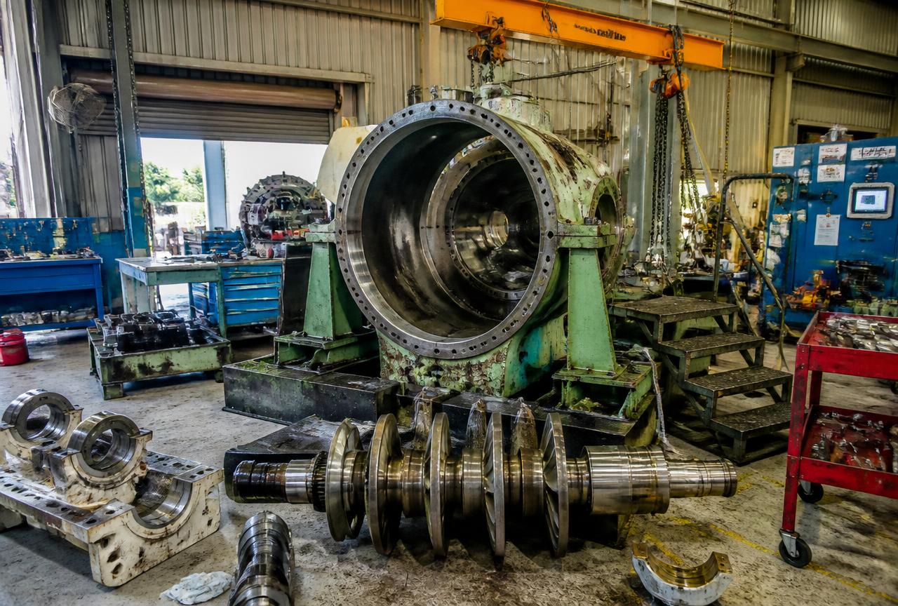 Large machine disassembled for overhaul in an engineering workshop
